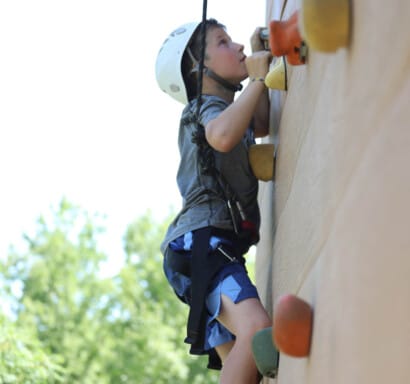 Camper on the climibing wall.