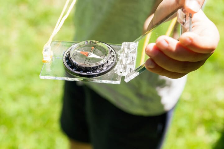 Camper holding a compass.