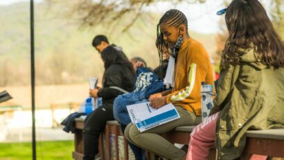 Campers writing in their notebooks.