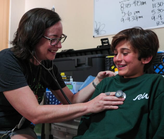 Nurse checking up on a camper.