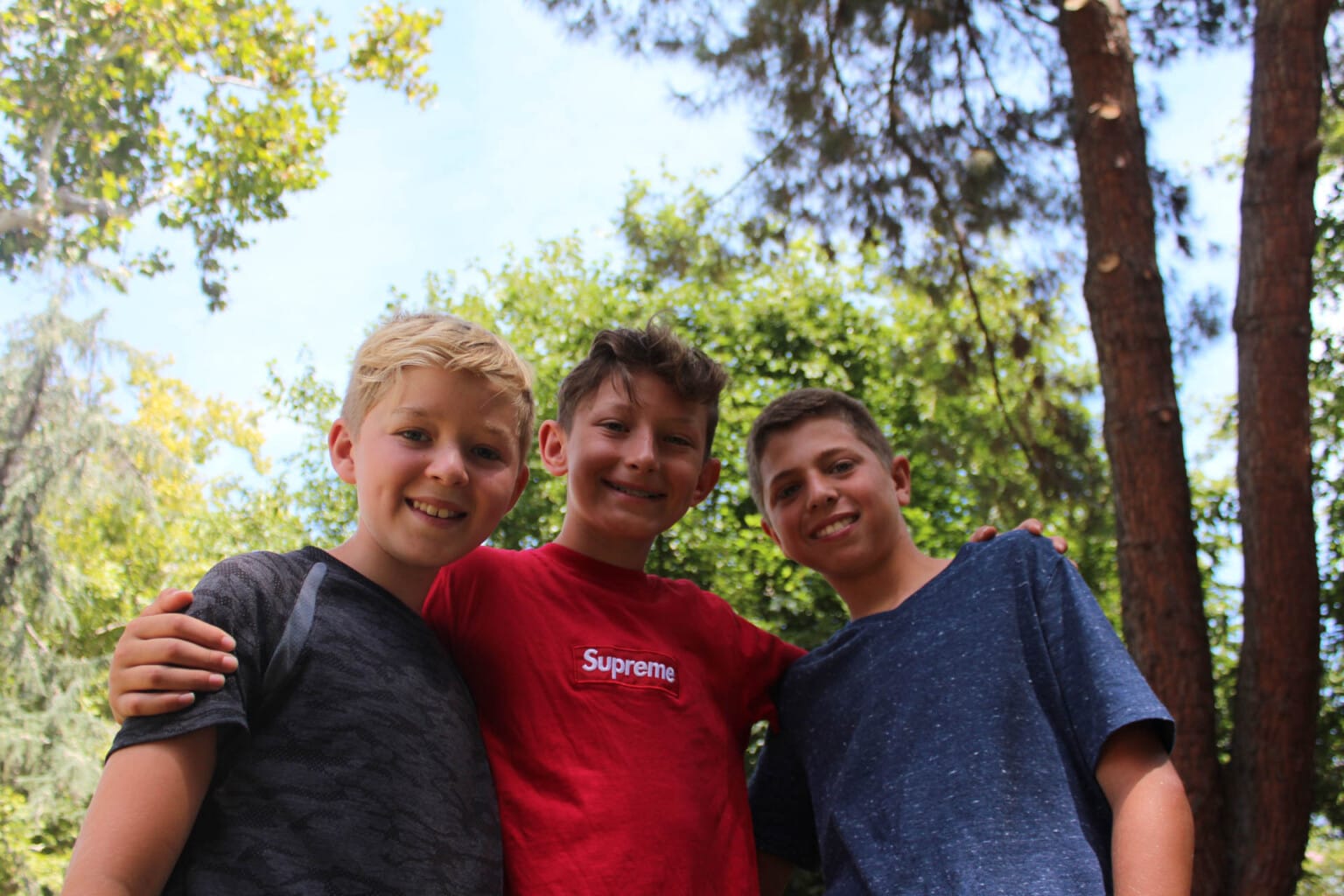 Three campers smiling together.