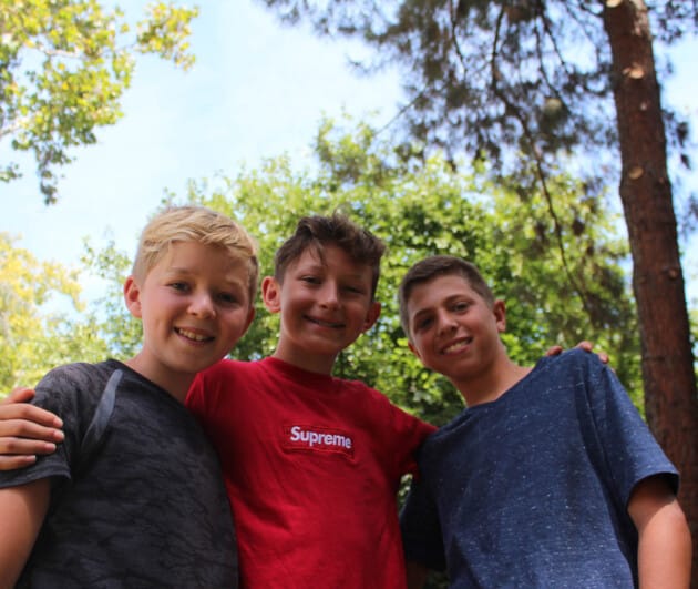 Three campers smiling together.