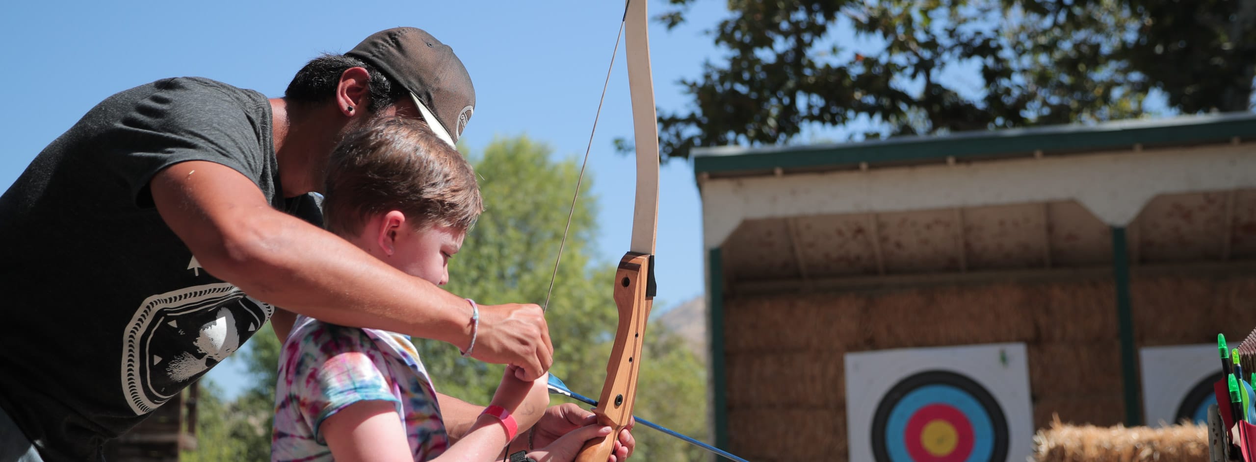 Instructor teaching archery.