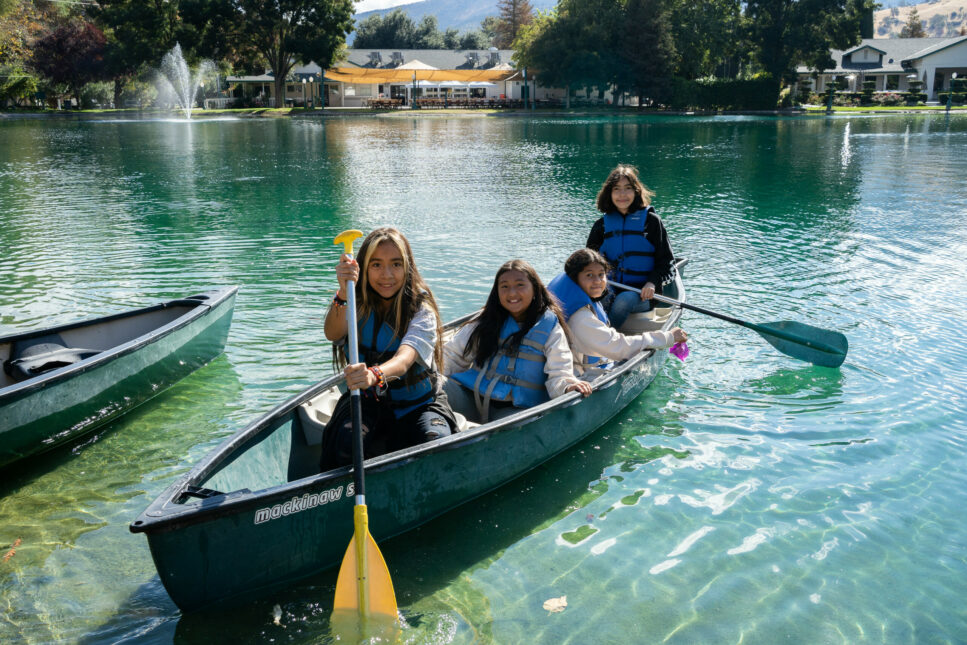 Students canoeing on the pond.
