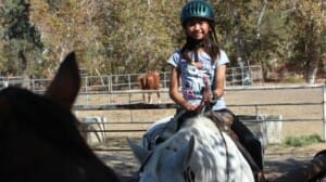 Camper riding a horse.