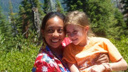 Camper and counselor in the mountains.