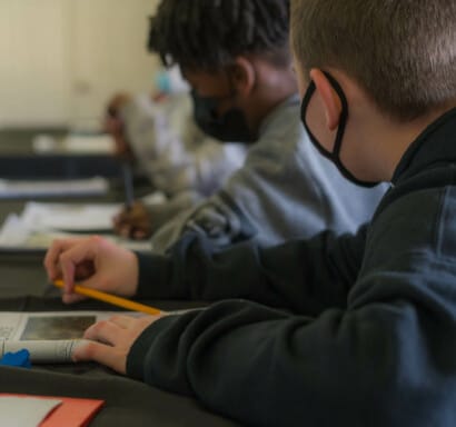 Campers working in workbooks.