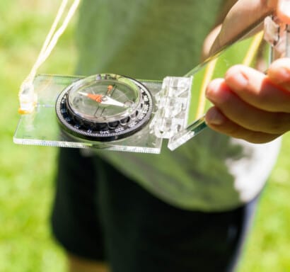 Camper holding a compass.