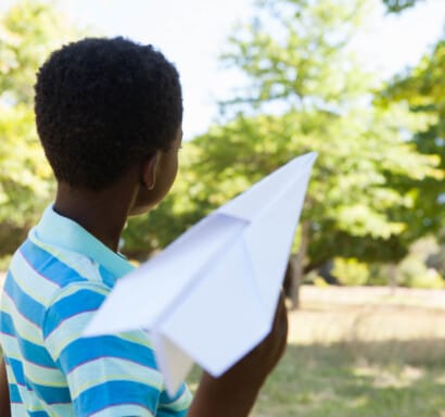 Camper about to throw a paper airplane.