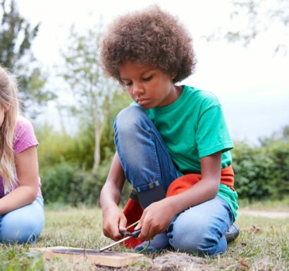 Campers starting fires with sticks.