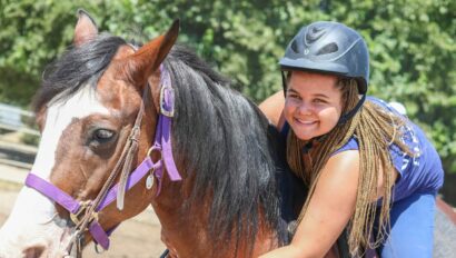 Camper smiling on a horse.