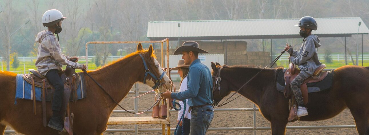 Man with kids on horses.