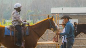 Man with kids on horses.